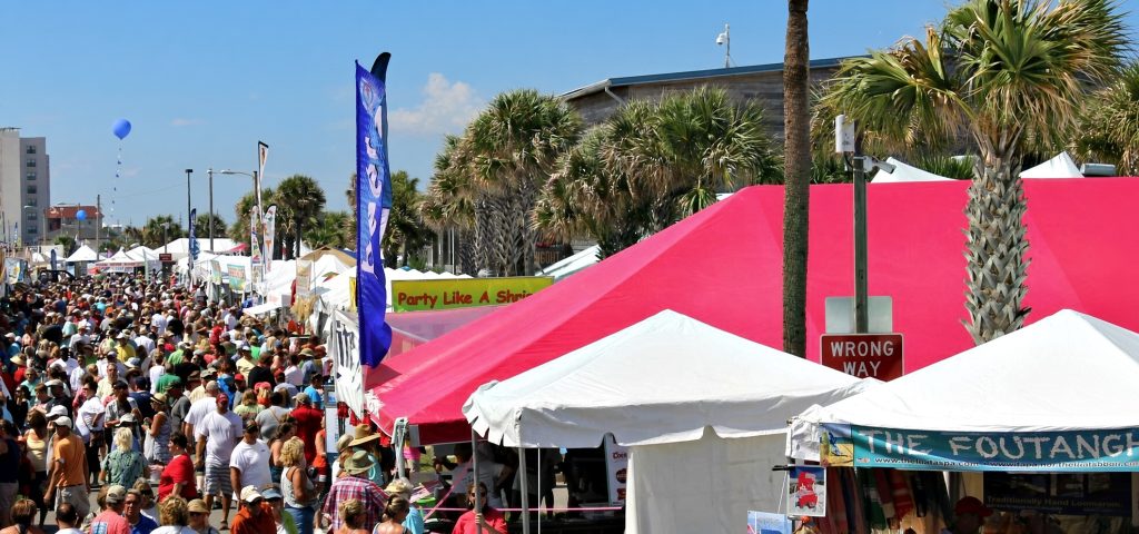 National Shrimp Festival in Gulf Shores, Alabama with tents and tourists.